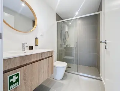 a bathroom with a toilet and a glass shower at Ninho Memory in Funchal