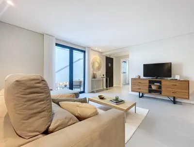 a living room with a couch and a flat screen tv at Ninho Memory in Funchal