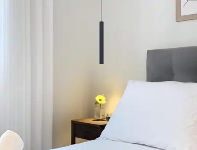 a bedroom with a bed with a yellow flower on a table at Ninho Memory in Funchal