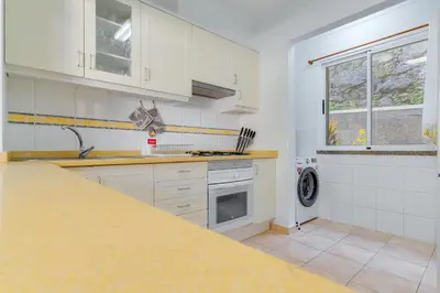 a kitchen with white cabinets and a counter top at Villa Holiday Sun by Holiday Rental Madeira in Ponta do Sol
