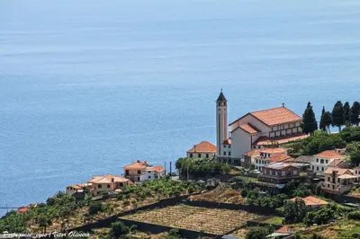 a small town on a hill next to the ocean at Villa Holiday Sun by Holiday Rental Madeira in Ponta do Sol