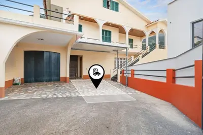 a house with a black door and a black marker at Atlantic View Studio in Ponta Delgada
