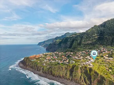 an aerial view of a town on a mountain next to the ocean at Atlantic View Studio in Ponta Delgada