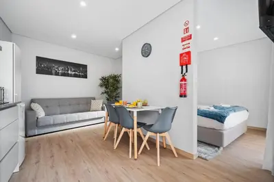 a living room with a table and chairs and a couch at Atlantic View Studio in Ponta Delgada