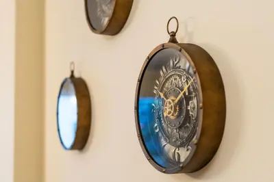 a group of clocks hanging on a wall at Famoso Grand Stay - Free Parking in Funchal