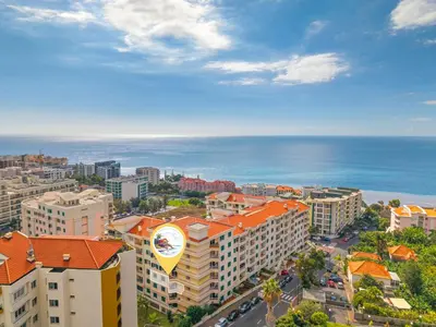an aerial view of a city with buildings and the ocean at Famoso Grand Stay - Free Parking in Funchal