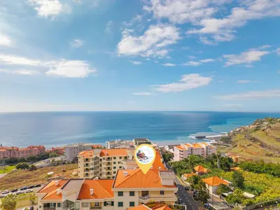 an aerial view of a city and the ocean at Famoso Grand Stay - Free Parking in Funchal