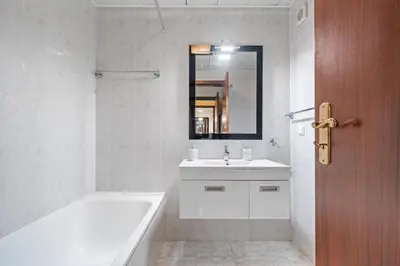 a white bathroom with a tub and a sink and a mirror at Famoso Grand Stay - Free Parking in Funchal