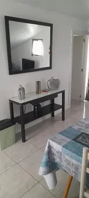 a room with a mirror and a table with vases on it at Sea view 2 bedrooms terrace Villa in Funchal