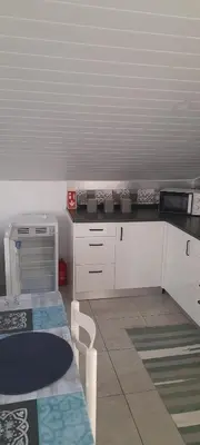 a kitchen with white cabinets and a counter top at Sea view 2 bedrooms terrace Villa in Funchal