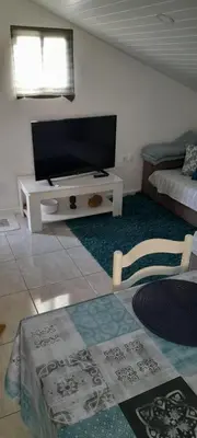 a living room with a flat screen tv and a bed at Sea view 2 bedrooms terrace Villa in Funchal