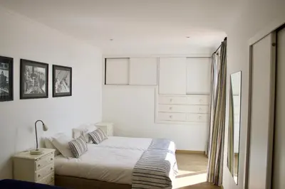 a white bedroom with a bed and a window at Santa Cruz Ocean Villa in Gaula