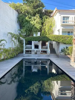 a swimming pool with a bench and a house at Santa Cruz Ocean Villa in Gaula