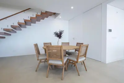 a dining room with a wooden table and chairs at Villa Rada, by Pausa Holiday Rentals in Estreito da Calheta