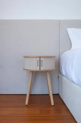 a small wooden table next to a bed at Villa Rada, by Pausa Holiday Rentals in Estreito da Calheta