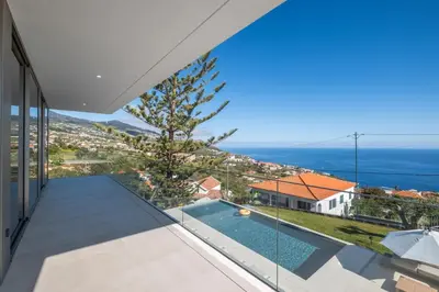 a view from the balcony of a house with a swimming pool at Villa Rada, by Pausa Holiday Rentals in Estreito da Calheta