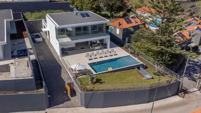an aerial view of a house with a swimming pool at Villa Rada, by Pausa Holiday Rentals in Estreito da Calheta