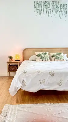 a bedroom with a bed with a white bedspread at The Luzia House - 4BR Villa - AC, large kitchen, living room, free parking, gardens, terraces, sun exposure all day - Coliving in Funchal