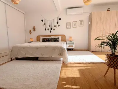 a bedroom with a bed and a potted plant at The Luzia House - 4BR Villa - AC, large kitchen, living room, free parking, gardens, terraces, sun exposure all day - Coliving in Funchal
