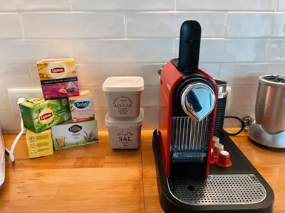 a coffee maker sitting on top of a counter at The Luzia House - 4BR Villa - AC, large kitchen, living room, free parking, gardens, terraces, sun exposure all day - Coliving in Funchal
