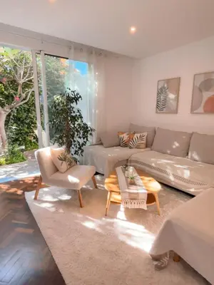 a living room with a couch and a table at The Luzia House - 4BR Villa - AC, large kitchen, living room, free parking, gardens, terraces, sun exposure all day - Coliving in Funchal