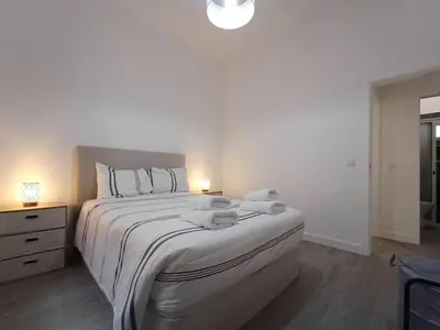 a bedroom with a bed with two stuffed animals on it at Sunset Cottage in Ponta do Sol