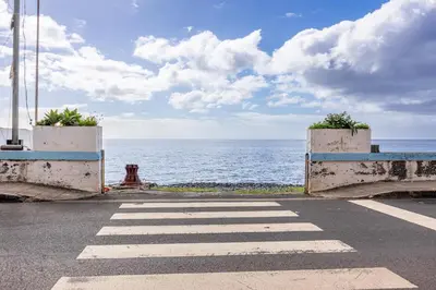 an empty street with a view of the ocean at Sunset Cottage in Ponta do Sol