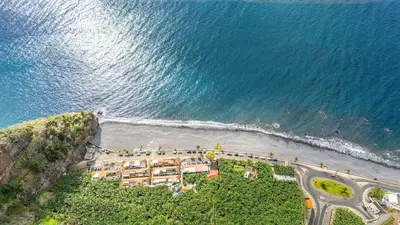 an aerial view of a resort on the beach at Sunset Cottage in Ponta do Sol