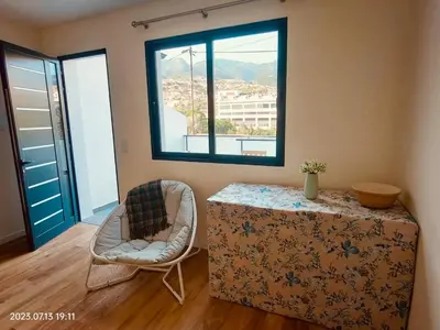 a room with a table and a chair and a window at Apartment with Mountain View in Funchal