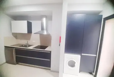 a small kitchen with a sink and a washing machine at Private Garden and Pool in the Heart of Funchal in Funchal