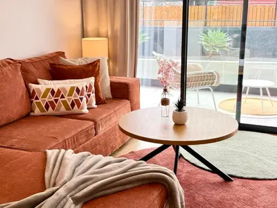 a living room with a couch and a table at Sunny Luxury Apartment Canico in Caniço