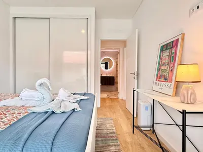 a bedroom with a bed with a swan on it at Sunny Luxury Apartment Canico in Caniço