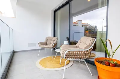 two chairs and a table on a balcony at Sunny Luxury Apartment Canico in Caniço
