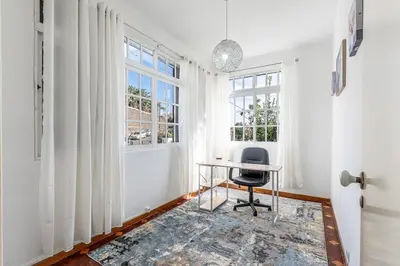 an office with a desk and a chair in a room at Serenity Sao Roque 2 Bedroom House in Funchal with Parking in Funchal