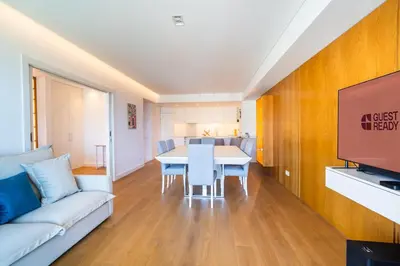 a living room with a table and a couch at GuestReady - Bright home with stunning views in Funchal