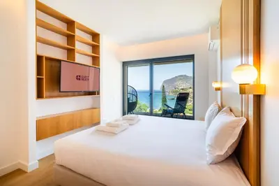a bedroom with a bed with a view of the ocean at GuestReady - Bright home with stunning views in Funchal