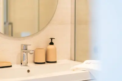 a bathroom sink with a mirror and a soap dispenser at GuestReady - Bright home with stunning views in Funchal
