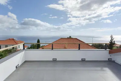 a white balcony with a view of the ocean at Sky and Sea Haven in Santa Cruz
