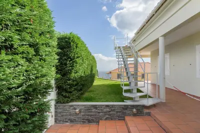 a staircase leading to a house with a large bush at Sky and Sea Haven in Santa Cruz