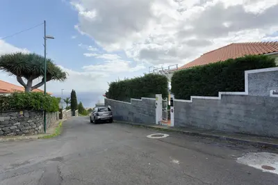a car parked on a street next to a retaining wall at Sky and Sea Haven in Santa Cruz