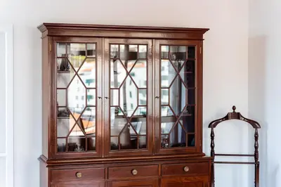 a wooden cabinet with stained glass windows at GuestReady - Wake Up to the Heartbeat of Madeira in Funchal