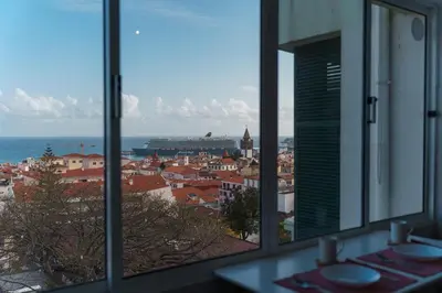 a view of a city from the window of a building at GuestReady - Wake Up to the Heartbeat of Madeira in Funchal