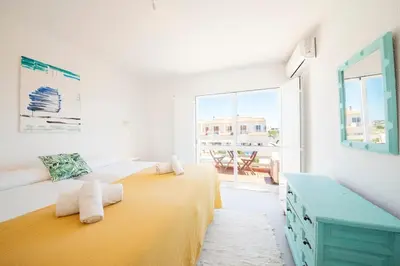 a white room with two beds and a window at Casa Lobitos Holiday Home with Pool - Sagres in Sagres
