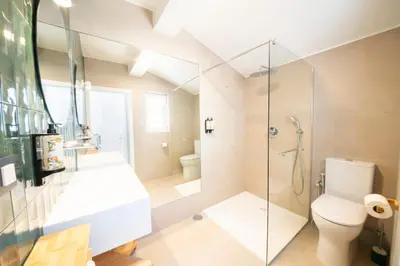 a bathroom with a shower and a toilet and a sink at Casa Lobitos Holiday Home with Pool - Sagres in Sagres