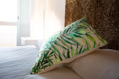 a pillow sitting on top of a bed at Casa Lobitos Holiday Home with Pool - Sagres in Sagres
