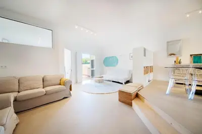a living room with a couch and a table at Casa Lobitos Holiday Home with Pool - Sagres in Sagres