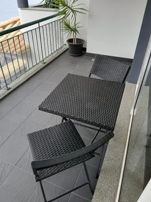 a balcony with two benches and a table at Al-Solares in Santa Cruz