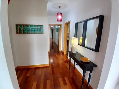a hallway with a table and a mirror on a wall at Al-Solares in Santa Cruz
