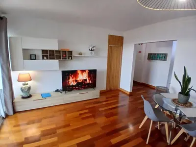 a living room with a fireplace and a table and chairs at Al-Solares in Santa Cruz