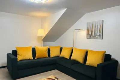 a bed in a room with yellow pillows at Casa Joao Batista em Machico in Machico